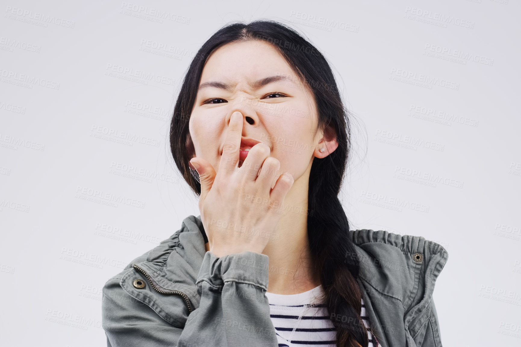 Buy stock photo Portrait, funny face and nose with an asian woman in studio on gray background looking silly or goofy. Comedy, comic and crazy with a happy young female person joking indoor for playful fun or humor