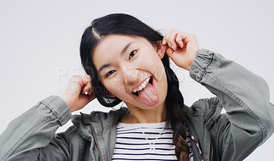 Buy stock photo Portrait, funny face and ears with an asian woman in studio on a gray background looking silly or goofy. Comedy, comic and crazy with a playful young female person joking indoor for fun or humor