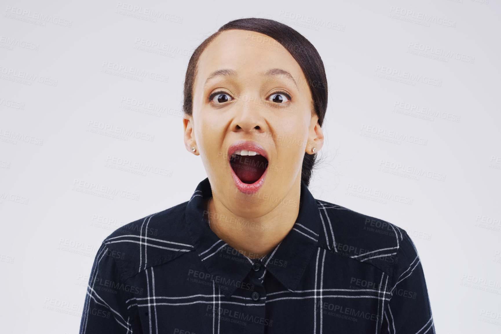 Buy stock photo Studio shot of a young woman making a funny face against a gray background