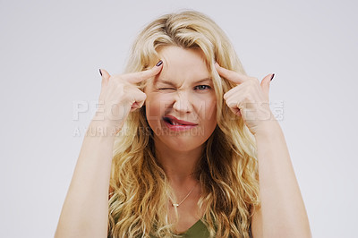 Buy stock photo Portrait, funny face and fingers on head with a woman in studio on a gray background looking silly or goofy. Comedy, comic and mental with a crazy young female person joking for fun or playful humor