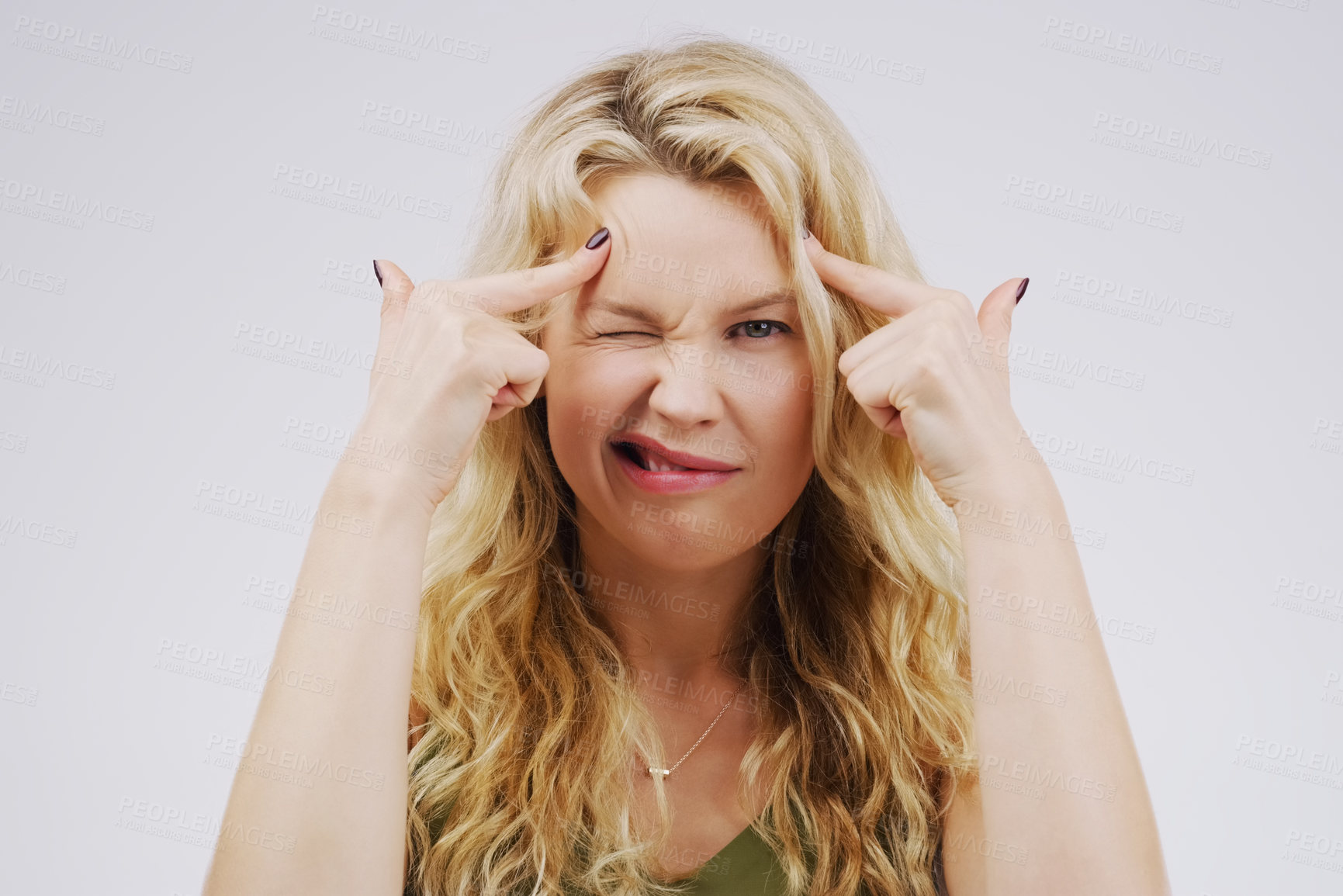 Buy stock photo Portrait, funny face and fingers on head with a woman in studio on a gray background looking silly or goofy. Comedy, comic and mental with a crazy young female person joking for fun or playful humor