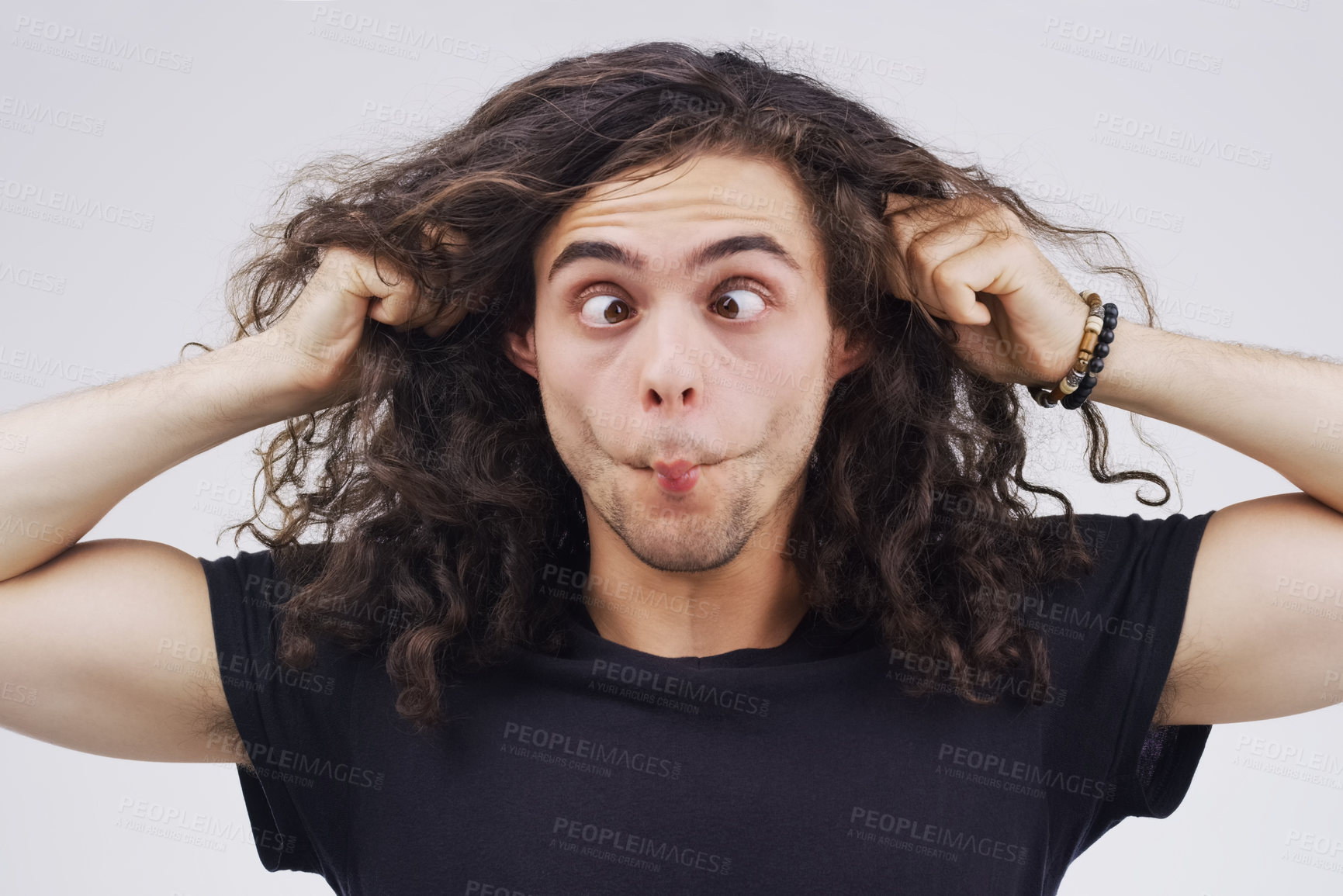 Buy stock photo Gen z man, crazy and funny in studio for face, emoji and ear pull by white background. Male person, comedian and  emotion for joke, prank and silly for humour and laugh on backdrop for comic gesture