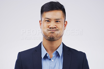 Buy stock photo Holding breath, portrait and Asian man in studio for funny face, fed up and annoyed on white background. Male person, comic and business fashion for comedy, humor and blown up cheeks for laugh