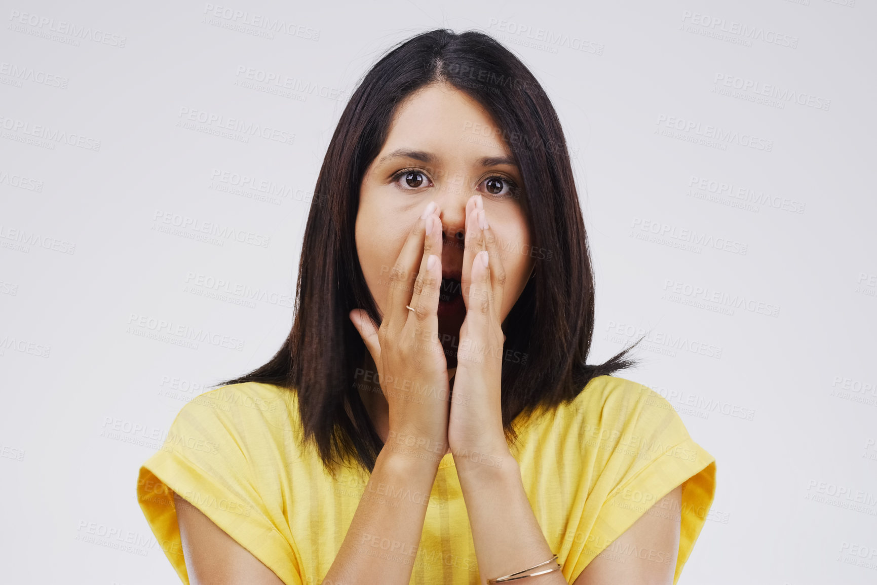 Buy stock photo Woman, surprised and portrait in studio for drama, horror and secret on white background. Shocked, alarm and female person with hands on face for wow, omg and reaction to meme or story in Colombia