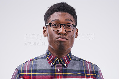Buy stock photo Funny face, young and portrait of a black man pouting isolated on a white background in a studio. Geek, pout and a face headshot of an African person with glasses as a nerd, goofy and quirky