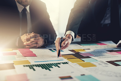 Buy stock photo Cropped shot of two unrecognizable businesspeople working at a desk in their office
