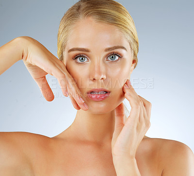 Buy stock photo Woman, portrait and makeup hands in studio, transformation and beauty on blue background. Female person, skincare and foundation for smooth skin, facial treatment and dermatology pride at salon