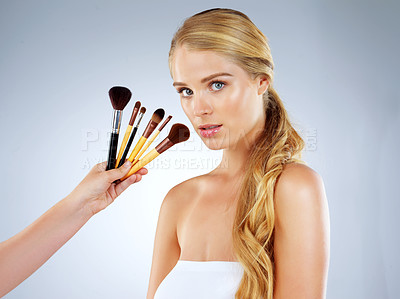 Buy stock photo Portrait, woman and studio with brush for makeup or cosmetic application, beauty and foundation of aesthetic. Female person, tools and salon for glamour, transformation and glow on gray background