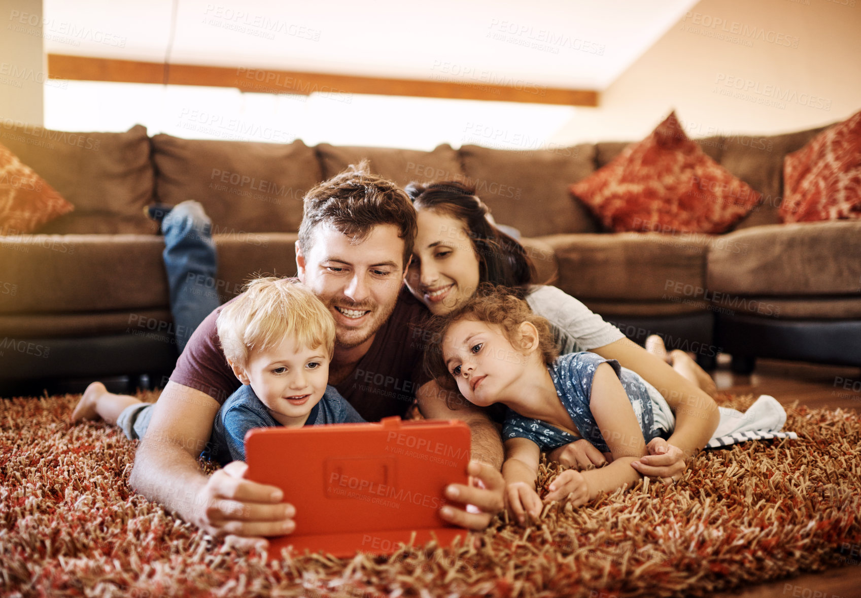 Buy stock photo Family, tablet and watching film in lounge together, relax and streaming subscription for cartoon movie. Parents, children and online for series in home, love and entertainment for happiness bonding 