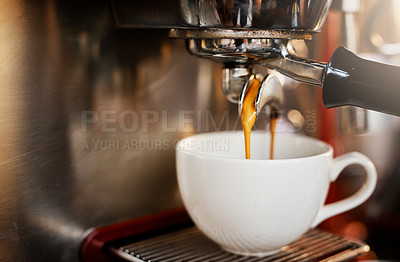 Buy stock photo Closeup shot of an espresso maker pouring coffee into a cup inside of a cafe