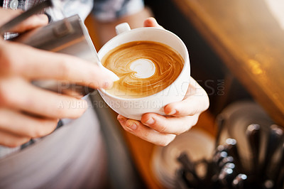 Buy stock photo A cropped shot of an unrecognizable barista pouring frothy milk into a cup of hot coffee turning it into a picture