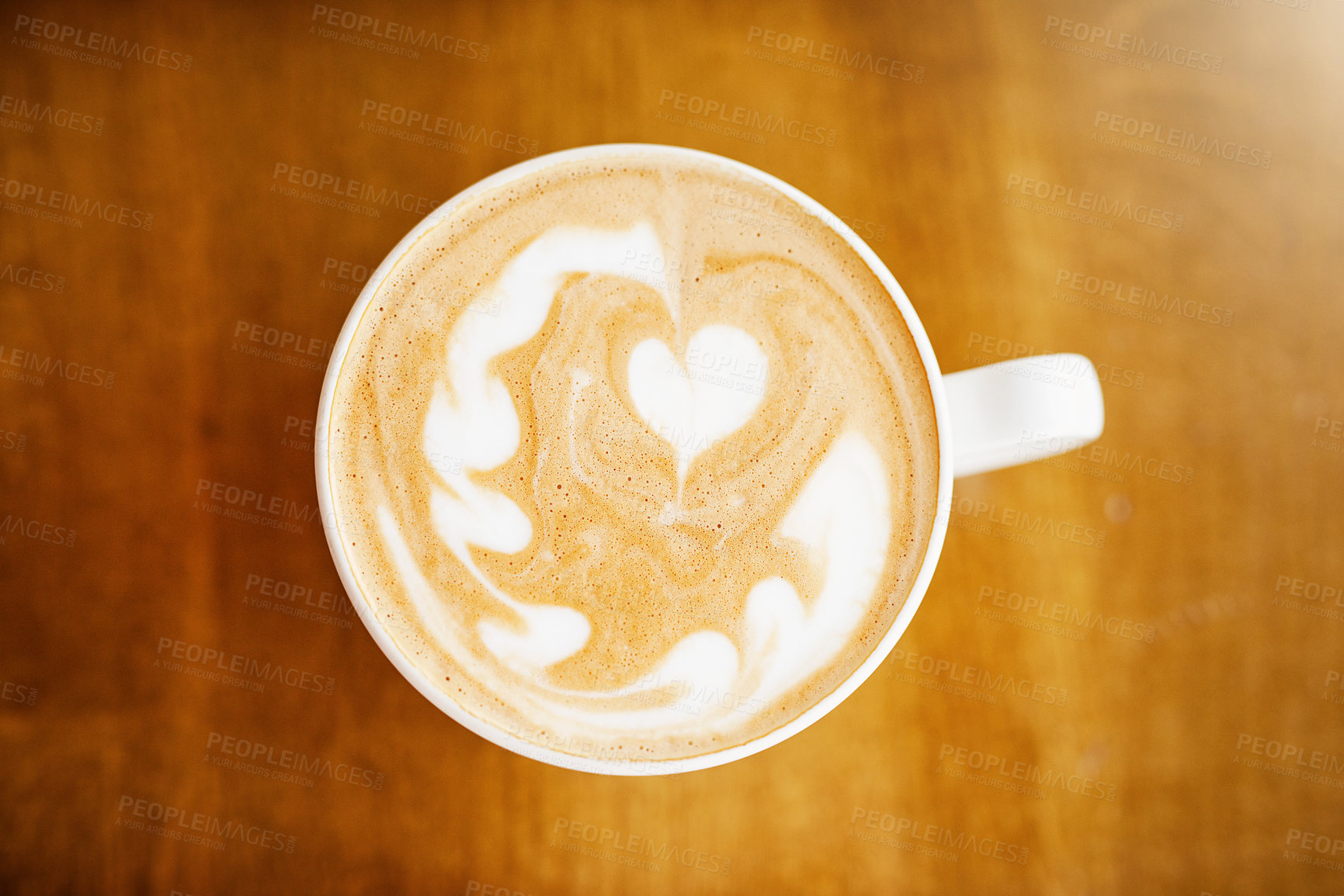 Buy stock photo High angle shot of a cup of coffee on a table in a coffee shop