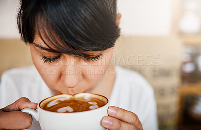 Buy stock photo Closeup of a beautiful young woman having a sip of her coffee she just bought inside of a cafe during the day