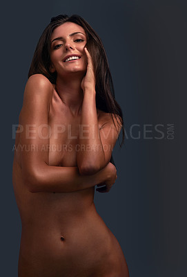 Buy stock photo Studio portrait of a beautiful young woman posing nude against a dark background
