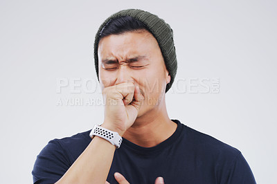 Buy stock photo Studio shot of a handsome young man coughing against a grey background