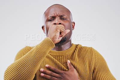 Buy stock photo Studio portrait of a handsome young man coughing against a grey background