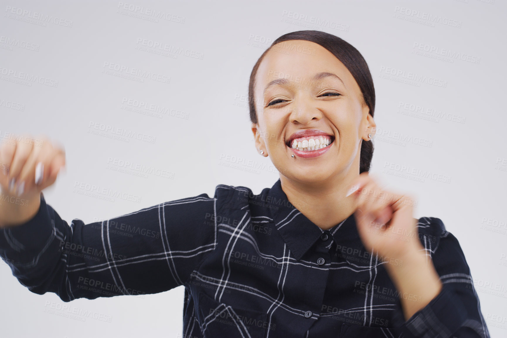 Buy stock photo Studio shot of an attractive young woman feeling cheerful and dancing against a grey background