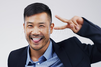 Buy stock photo Studio shot of a handsome businessman feeling cheerful and dancing against a grey background