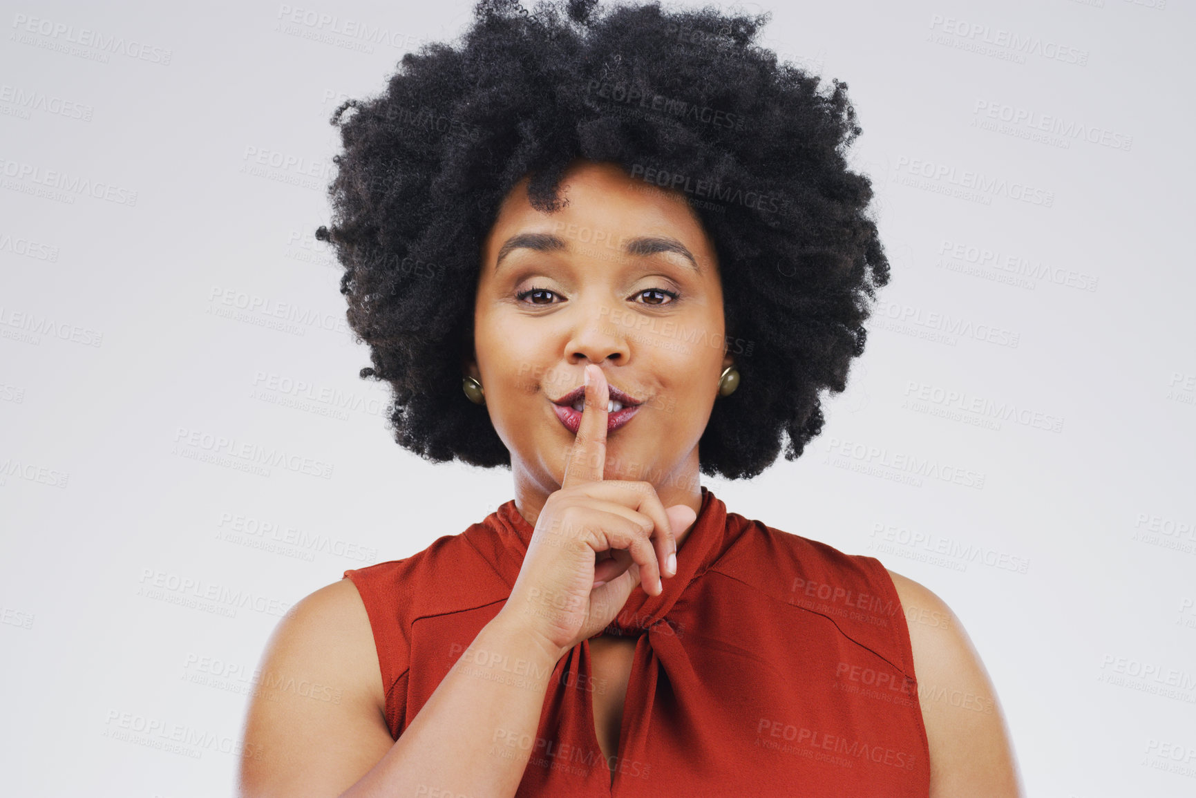 Buy stock photo Portrait of an attractive young woman posing with her finger on her lips against a grey background