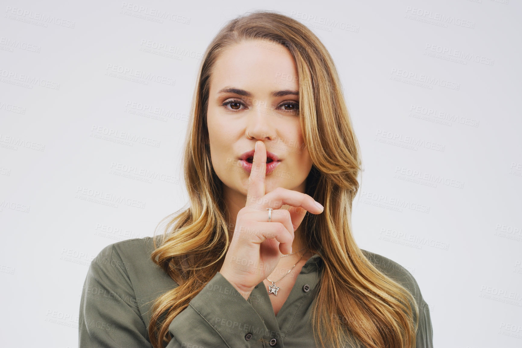 Buy stock photo Woman, portrait and finger with hush, studio and silence for mystery announcement. Model, gossip and secret with rumor, whisper and gesture for news or noise with confidential on white background