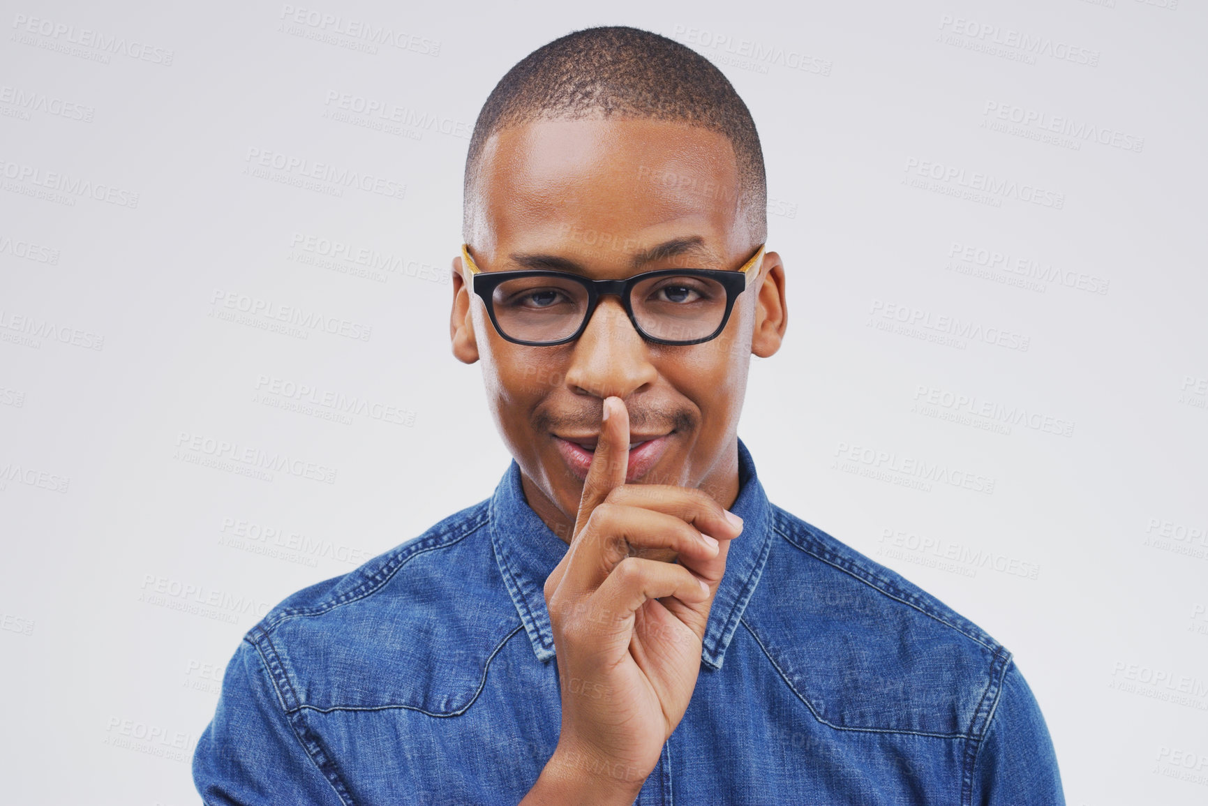 Buy stock photo Portrait, glasses and shush with quiet black man in studio isolated on gray background for mystery. Face, finger on lips and secret with emoji hand gesture of private person to whisper in eyewear