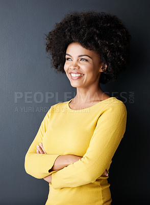 Buy stock photo Studio shot of an attractive young woman standing with her arms crossed against a grey background