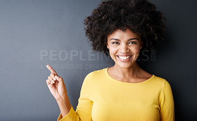 Buy stock photo Black woman, pointing and happy portrait in studio, mockup and gray background with announcement information. Hand, sign or face of person with opinion, advice or positive choice and gesture to promo