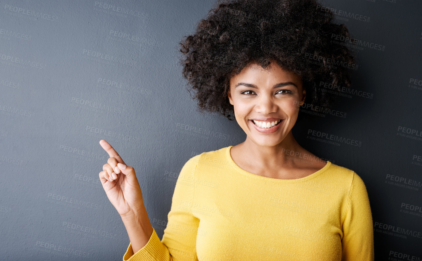 Buy stock photo Black woman, pointing and happy portrait in studio, mockup and gray background with announcement information. Hand, sign or face of person with opinion, advice or positive choice and gesture to promo