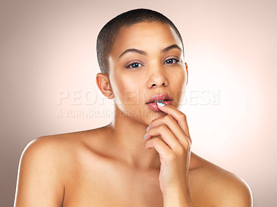 Buy stock photo Portrait, skincare and beauty of serious woman in makeup for wellness or health in studio isolated on brown background. Face, bald and young model in cosmetics for glow, shine and dermatology in spa