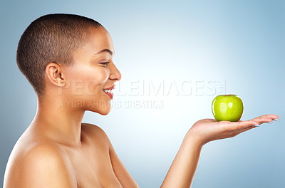Buy stock photo Studio, apple or profile of happy woman giving healthy choice or offer mockup space on blue background. Vegan, hand or girl with smile for fruit or food for fiber, detox diet or vitamin c nutrition