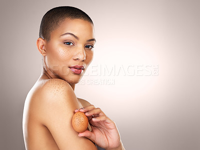 Buy stock photo Studio shot of a beautiful young woman holding a egg against her skin