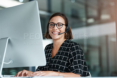 Buy stock photo Cropped portrait of a happy young call centre agent working 
 on a computer in an office