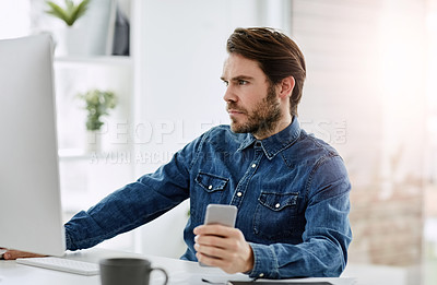 Buy stock photo Cropped shot of a handsome young businessman working on a computer in his office
