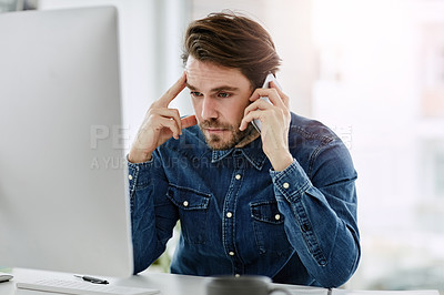 Buy stock photo Cropped shot of a handsome young businessman looking frustrated while making a phonecall in his office