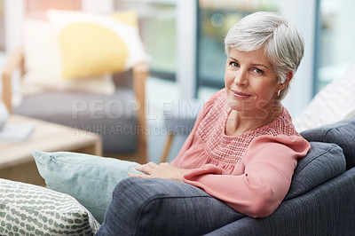 Buy stock photo Shot of a beautiful mature woman relaxing on a sofa at home