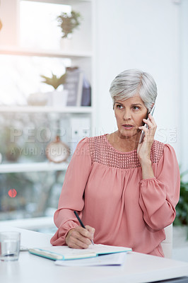 Buy stock photo Shot of mature businesswoman taking a phone call at her office desk at work