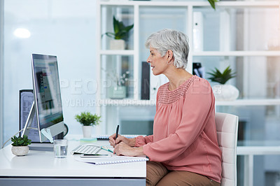 Buy stock photo Shot of a mature woman working on a computer in her office at work