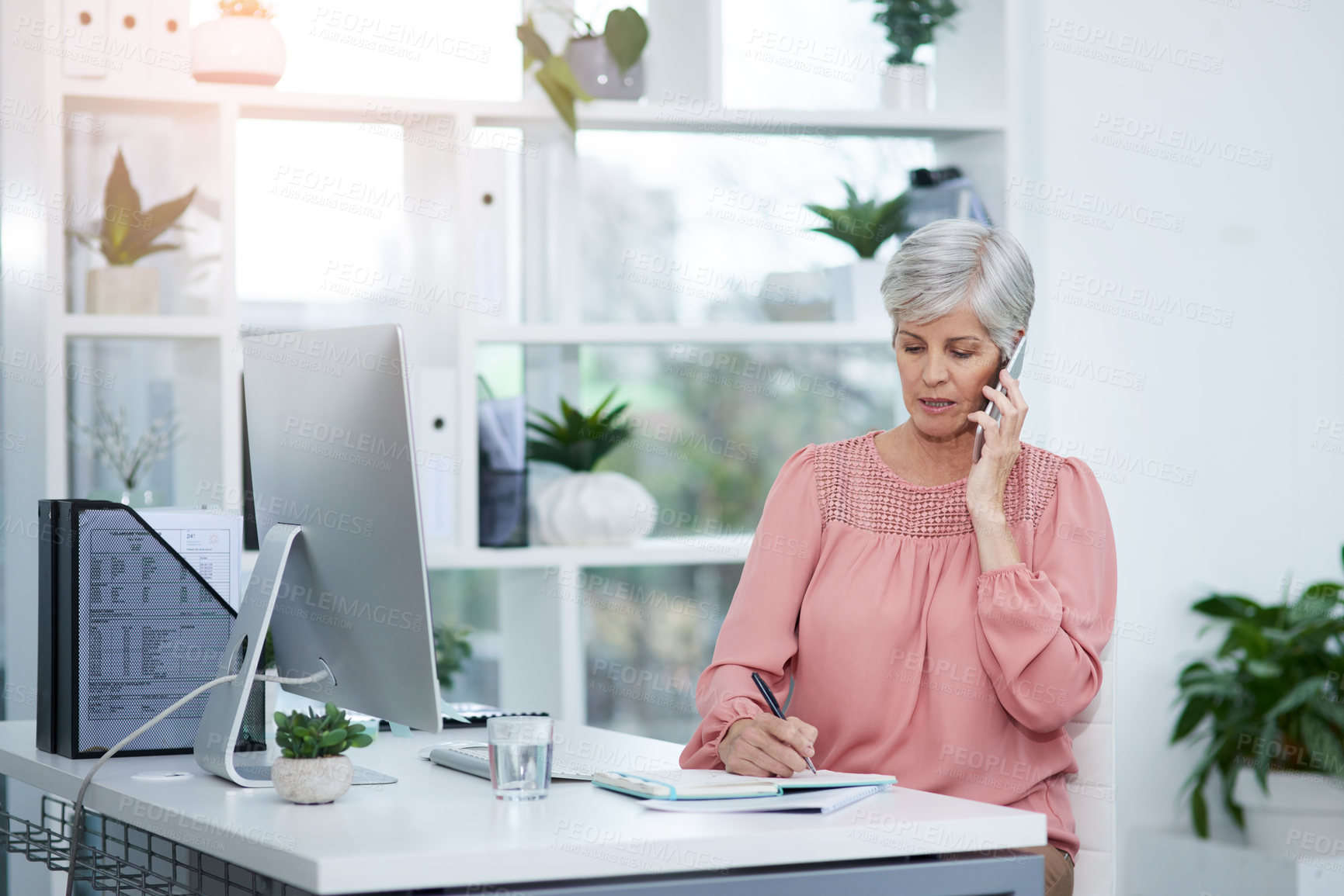 Buy stock photo Shot of mature businesswoman taking a phone call at her office desk at work