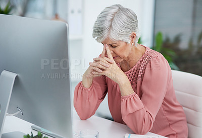 Buy stock photo Shot of a mature woman looking stressed out in her office at work