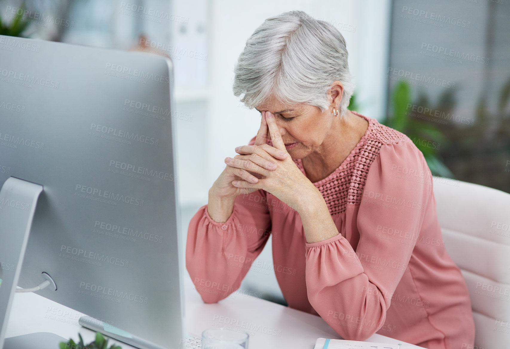 Buy stock photo Shot of a mature woman looking stressed out in her office at work