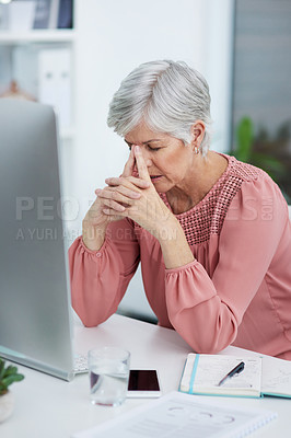 Buy stock photo Shot of a mature businesswoman suffering from a headache in her office at work
