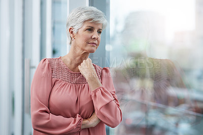 Buy stock photo Shot of a mature businesswoman looking thoughtful in her office at work