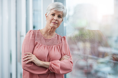 Buy stock photo Portrait of a mature businesswoman posing with her arms folded in her office  at work