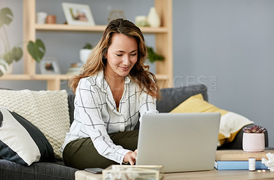 Buy stock photo Shot of an attractive businesswoman working on her laptop at home
