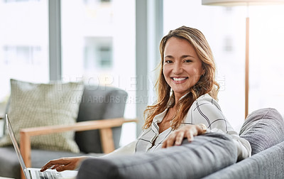 Buy stock photo Portrait of an attractive businesswoman working on her laptop at home