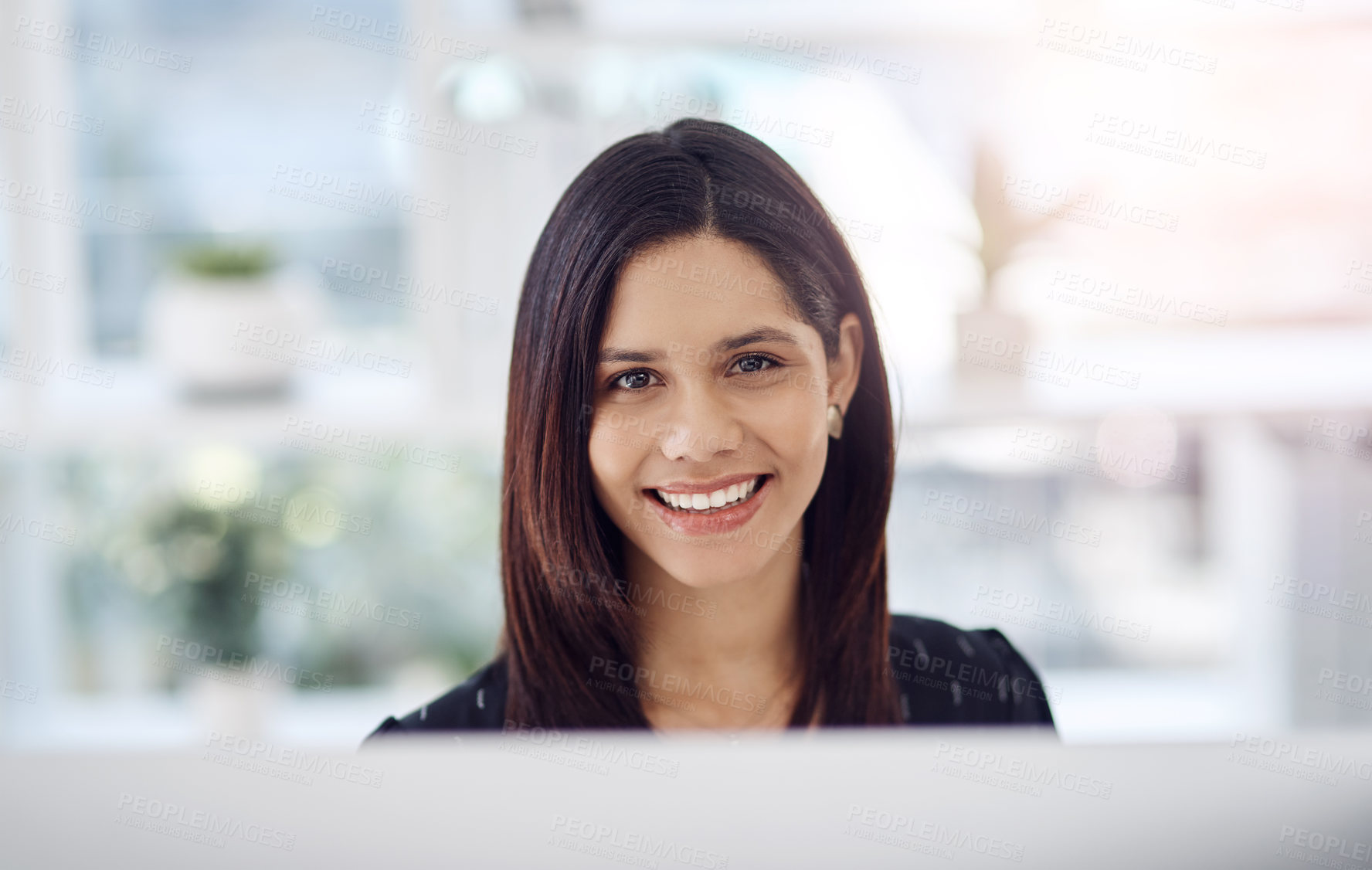 Buy stock photo Portrait of an attractive young businesswoman sitting down at her office desk at work