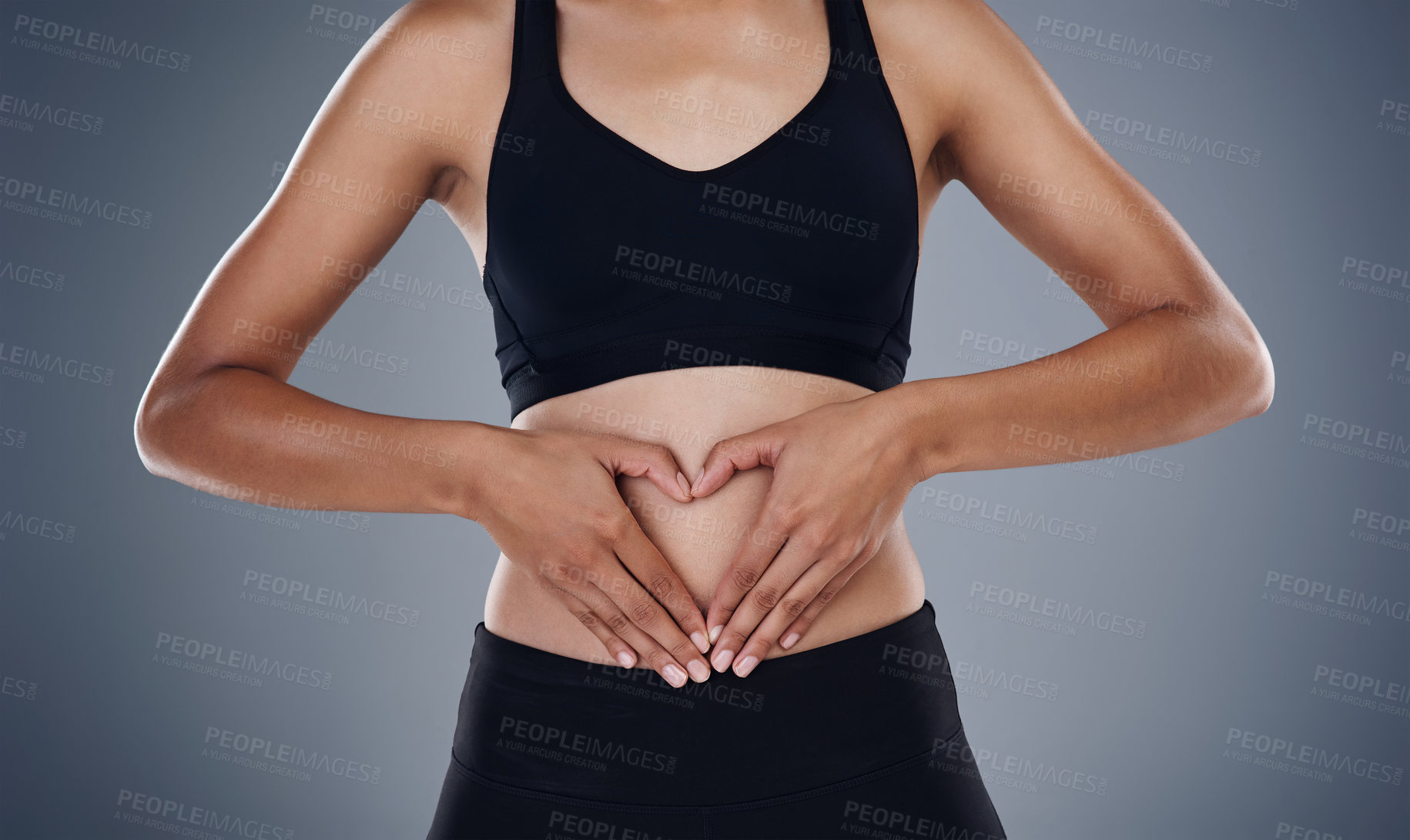 Buy stock photo Studio shot of a sporty young woman standing against a grey background 