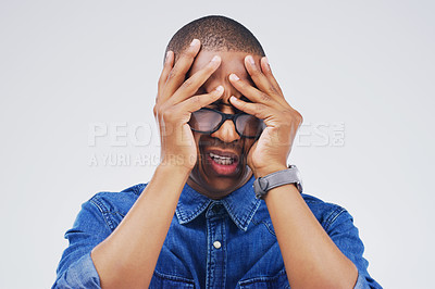 Buy stock photo Studio shot of a handsome young man looking stressed out against a grey background