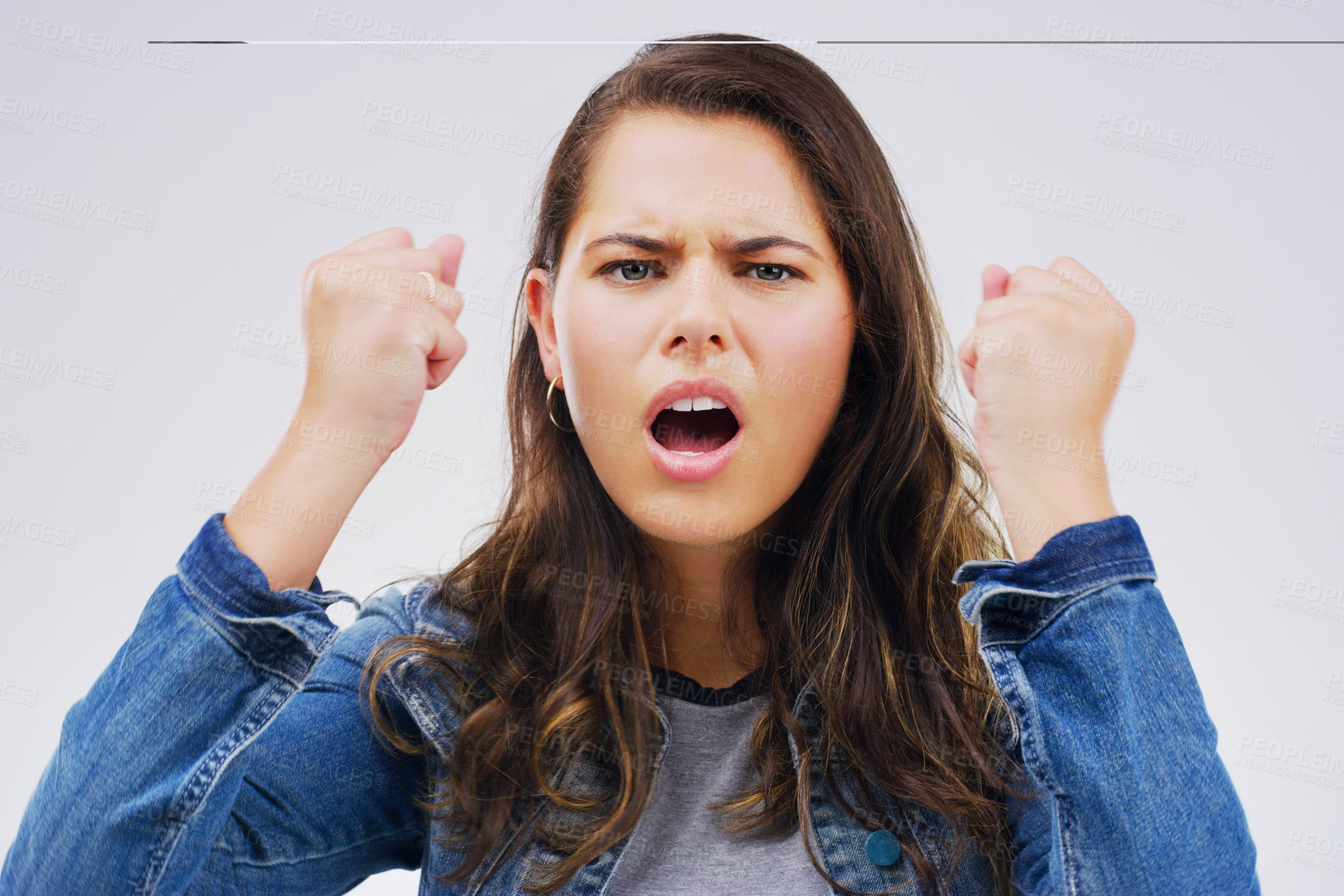 Buy stock photo Angry, conflict and frustration with portrait of woman in studio isolated on gray background. Face, fail or fist and face of unhappy young person feeling annoyed with crisis or negative emotion
