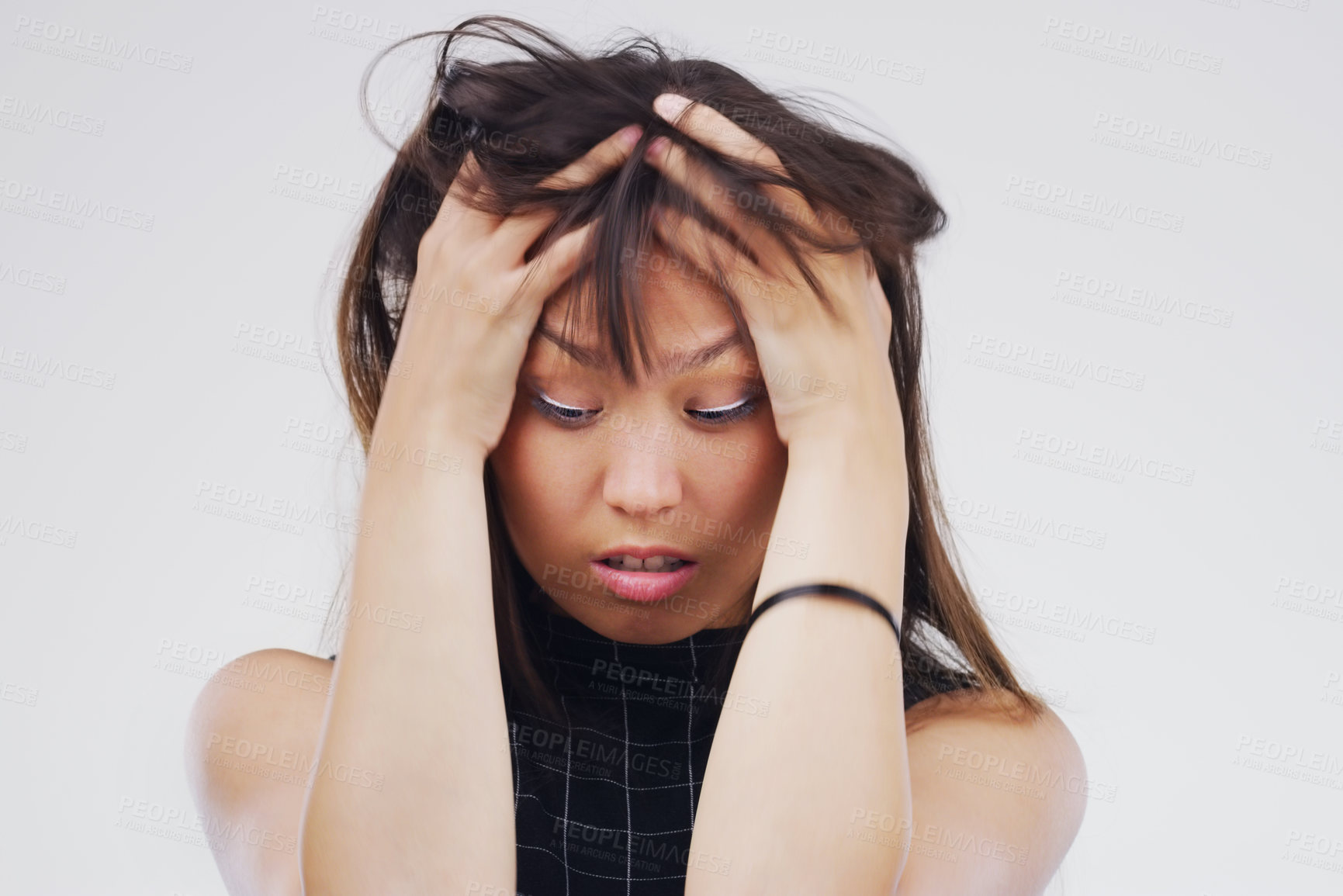 Buy stock photo Studio shot of an attractive young woman looking stressed out against a grey background